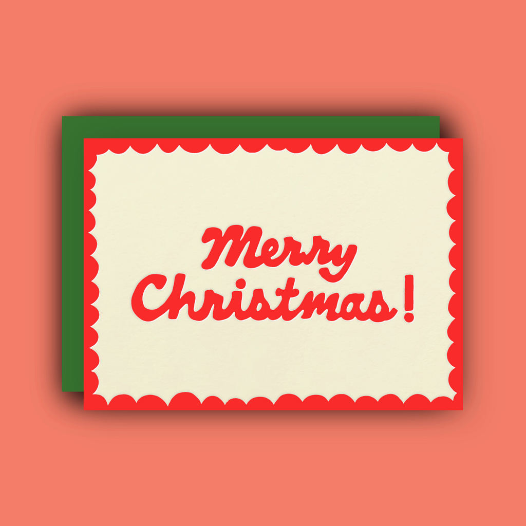 An ivory card with a bright red scalloped border and the words, "Merry Christmas!" written in cursive. 