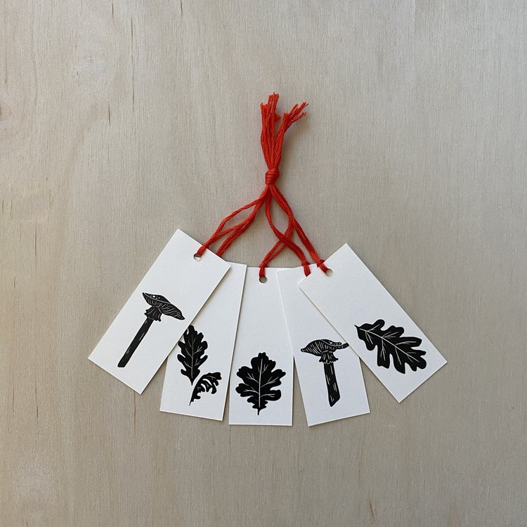 gift tag set featuring mushrooms and leaves with red thread