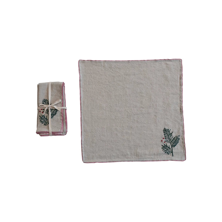 Add some elegance and charm to the holiday table with these holly-embroidered napkins. This set of four napkins features a delicate and intricate design of holly leaves and berries, French knots, and blanket stitch, all done by hand in green and red threads on a natural cotton and linen blend fabric. The napkins have a square shape and a generous size, making them ideal for wrapping cutlery, wiping spills, or simply adding some color and texture to any table.&nbsp;