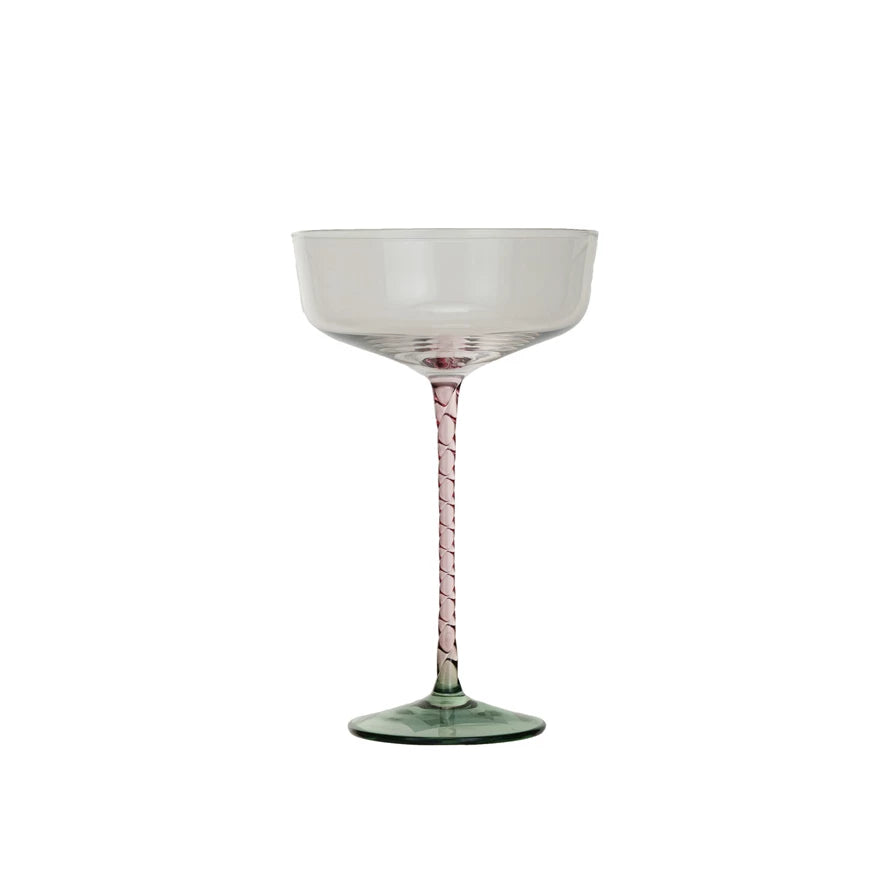 This 10 oz. champagne glass is a celebration in itself, featuring a clear bowl that sits atop a distinctively colored stem in pink and a green base. The round coupe design is a nod to vintage glamour, while the modern hues inject a contemporary edge. Perfect for special occasions or as a standout piece in the glassware collection, this glass elevates any champagne or cocktail serving. Its generous size and elegant stem ensure a comfortable hold and a beautiful presentation.