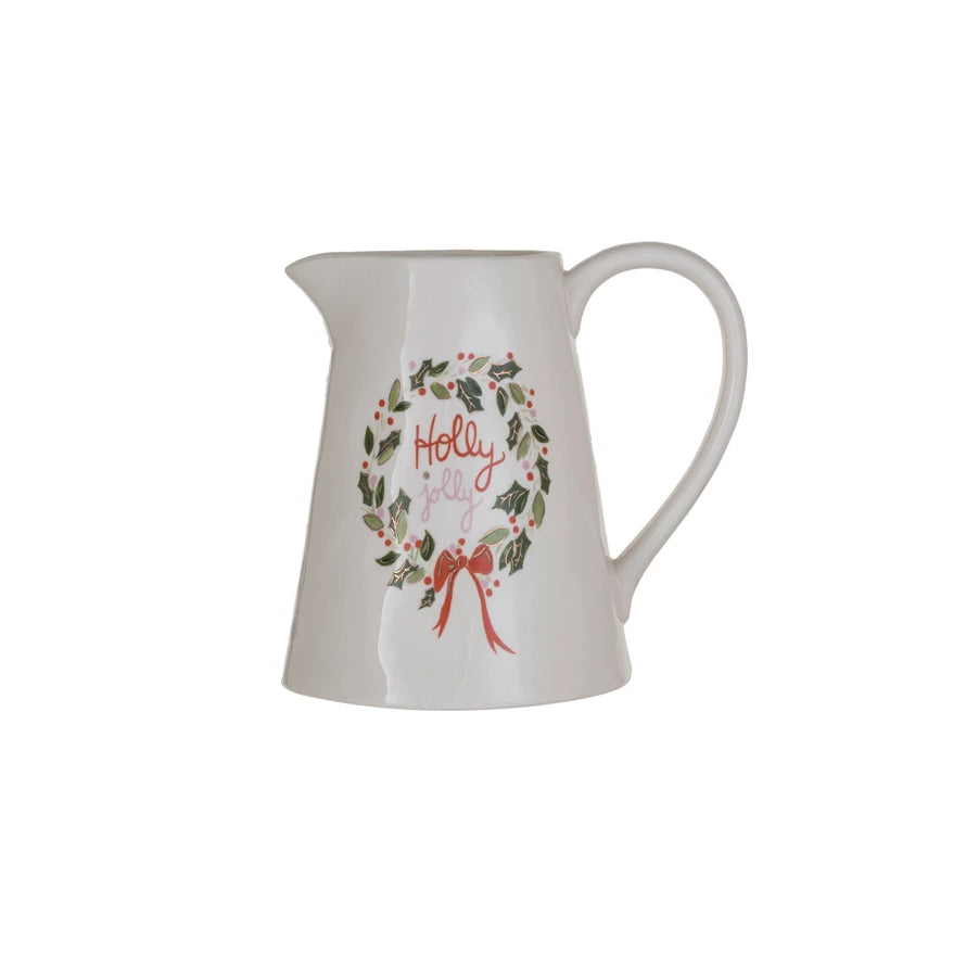 This "Holly Jolly" stoneware pitcher, adorned with gold electroplating, is a merry addition to the holiday decor. Its vibrant colors and festive inscription are complemented by the luxurious touch of gold, making it a dazzling piece for any celebration. 