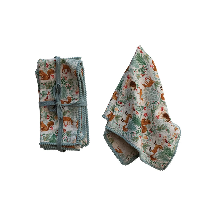 Add some charm and personality to the dining experience with these woodland flora and fauna napkins with pom-pom trim. This set of four square napkins features a delightful woodland flora and fauna pattern in multicolor, complemented by a playful pom-pom trim that adds texture and movement. These napkins are made of cotton and polyester, a blend that offers both softness and durability.&nbsp;