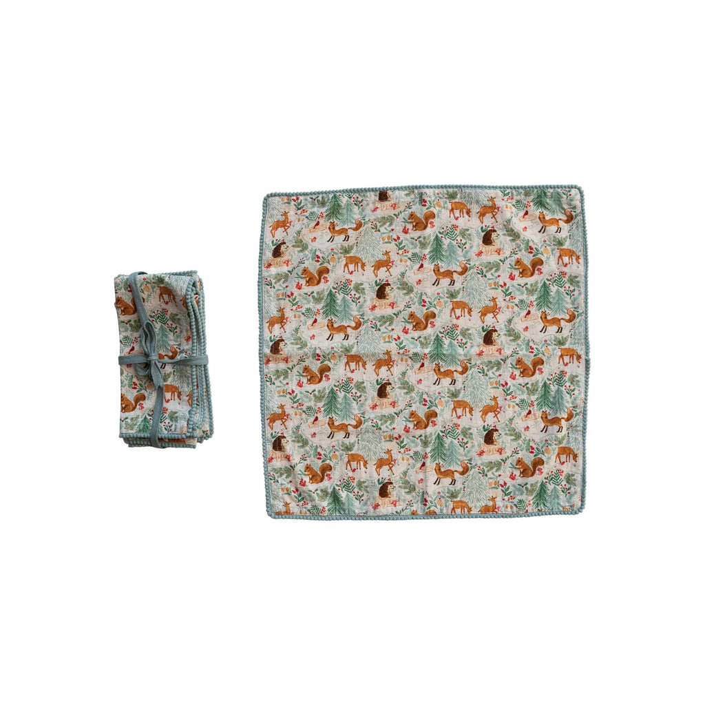 Add some charm and personality to the dining experience with these woodland flora and fauna napkins with pom-pom trim. This set of four square napkins features a delightful woodland flora and fauna pattern in multicolor, complemented by a playful pom-pom trim that adds texture and movement. These napkins are made of cotton and polyester, a blend that offers both softness and durability.&nbsp;