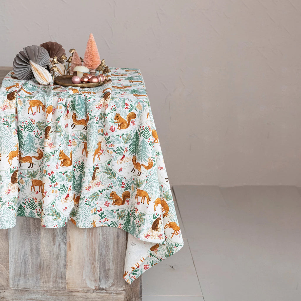 Add some beauty and whimsy to the dining table with this cotton-printed tablecloth with a woodland flora and fauna pattern. This tablecloth is a stunning and unique piece that features various animals, plants, and flowers in multicolor, creating a woodland flora and fauna pattern that is both charming and captivating. The tablecloth can transform any dining table into a magical forest scene, bringing some nature and wonder to any space