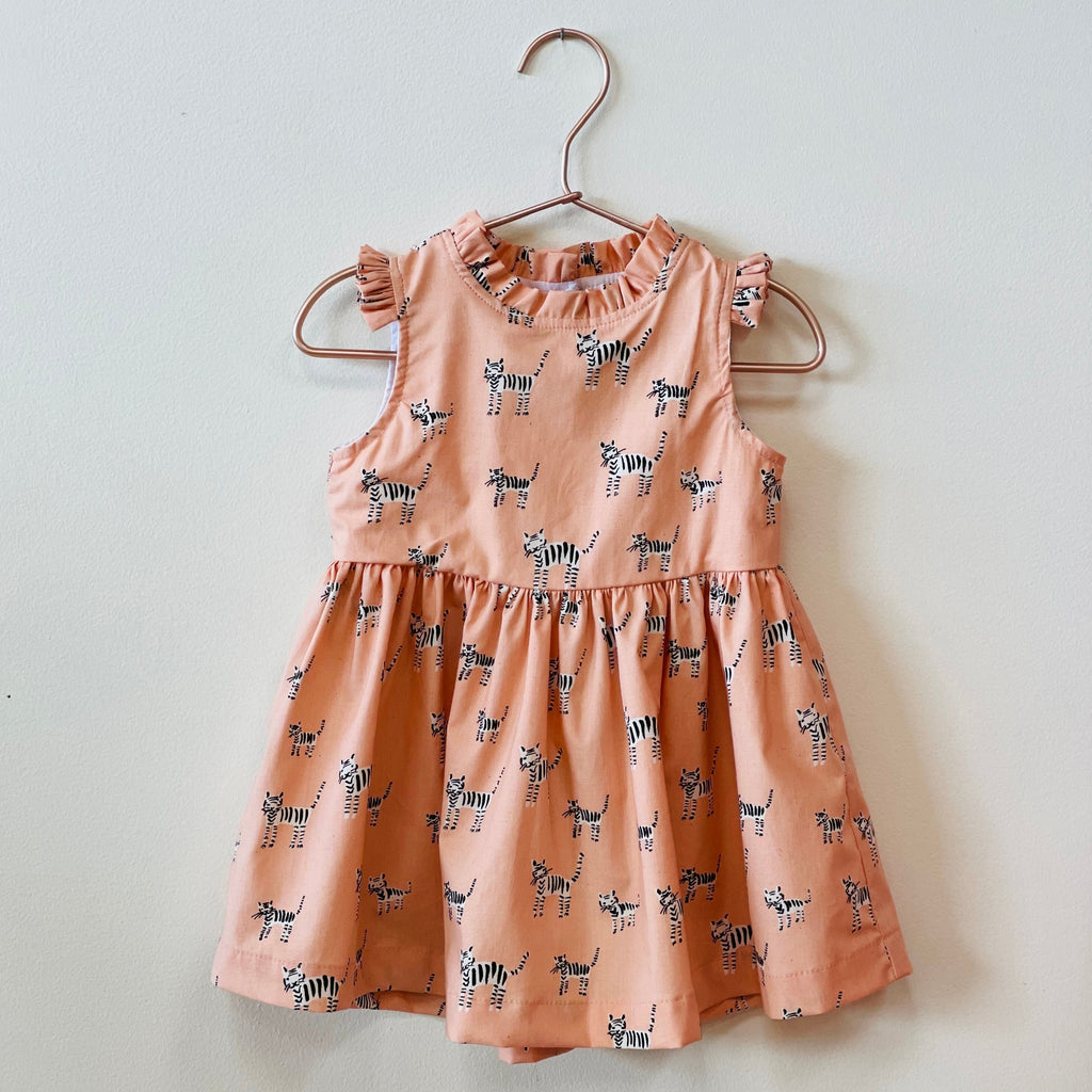 Treat your little one to a unique style statement with our Lily - Pink Tigers Dress! Crafted from a comfortable cotton linen blend, this hard-to-miss dress makes for a purrrfect addition to their wardrobe - go wild!   Made for play or the ballet these made-in-Utah dresses are small batch, high quality and made to be passed on to generations to come.